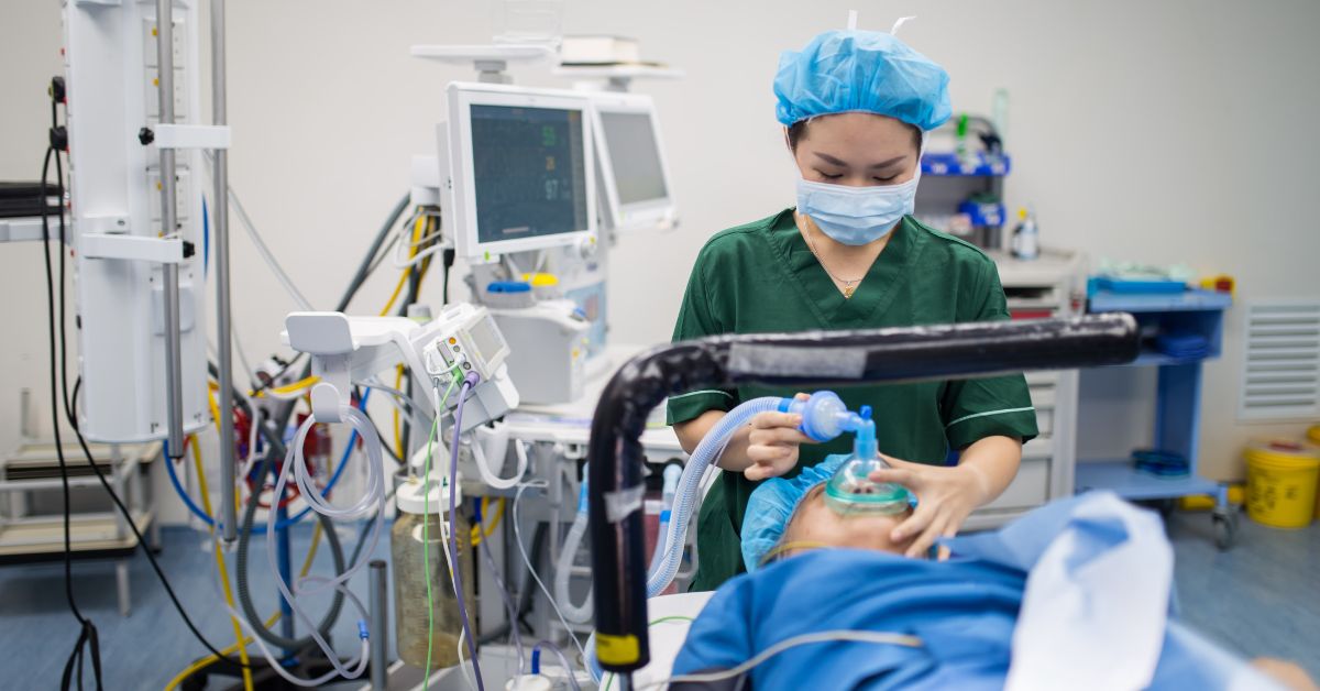 Doctor giving patient oxygen in a hospital theatre